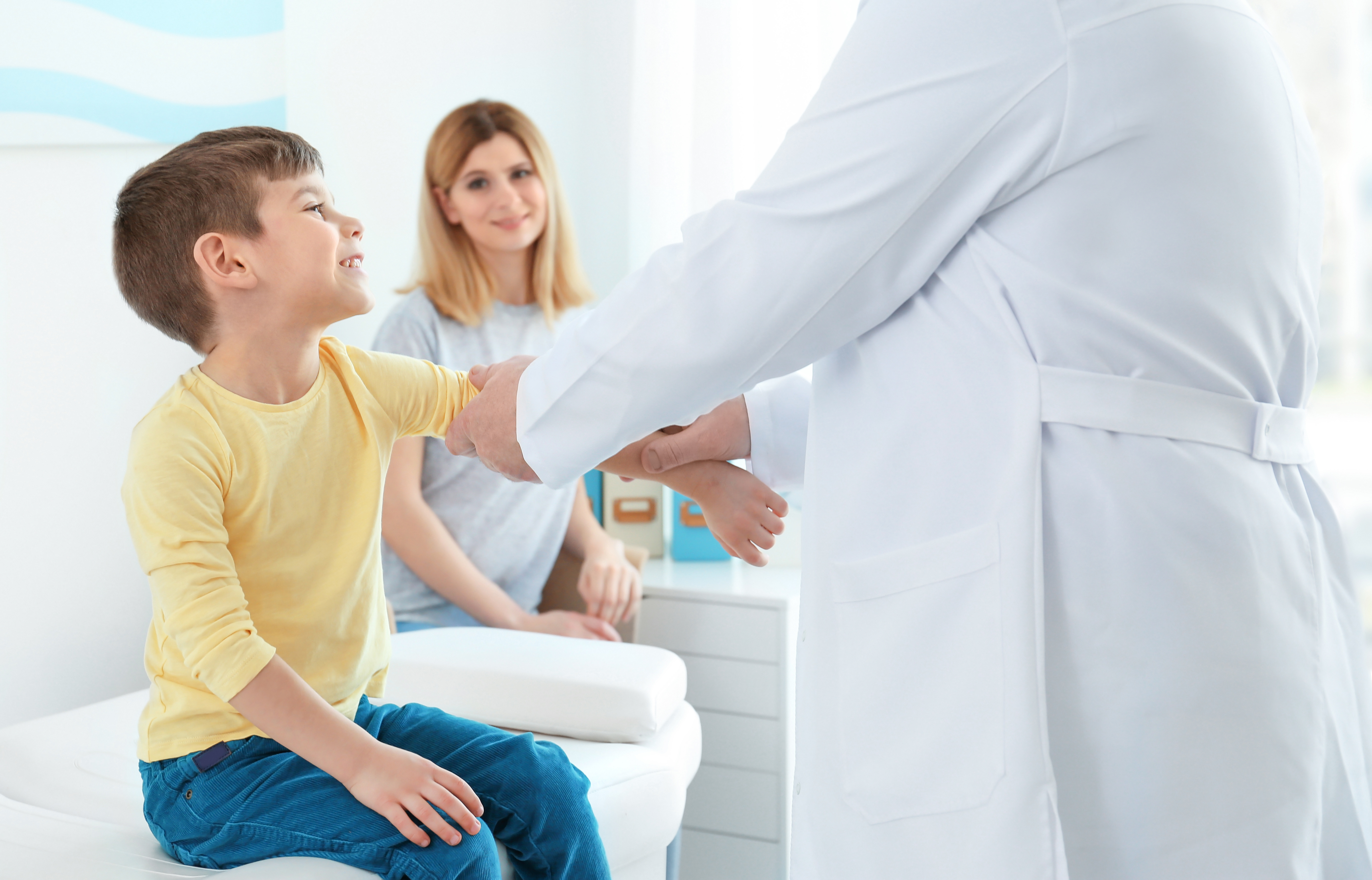 Child’s Sports Physical; Little boy with mother at orthopedist's office