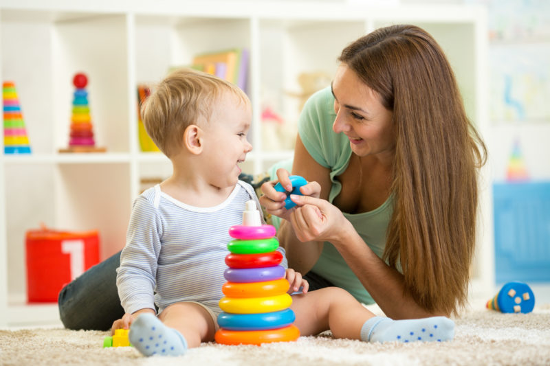 7 Questions Every Parent Needs to Ask a Potential Babysitter; babysitter and child boy play together indoors at home