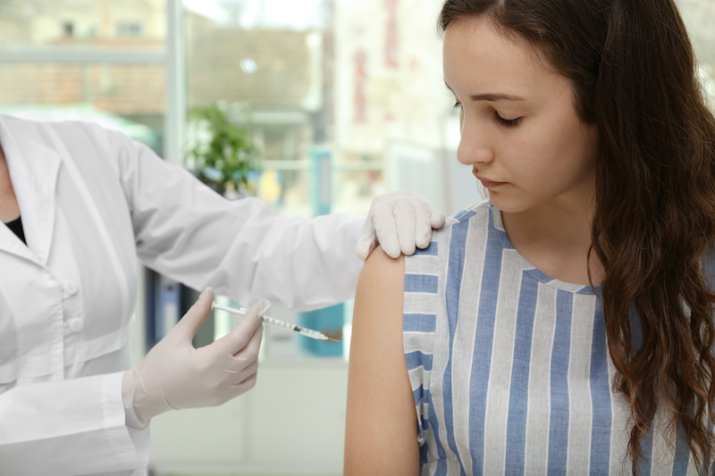Young girl receiving vaccination in hospital: Blog: The HPV Vaccine: Facts to Consider for Your Preteen or Teen