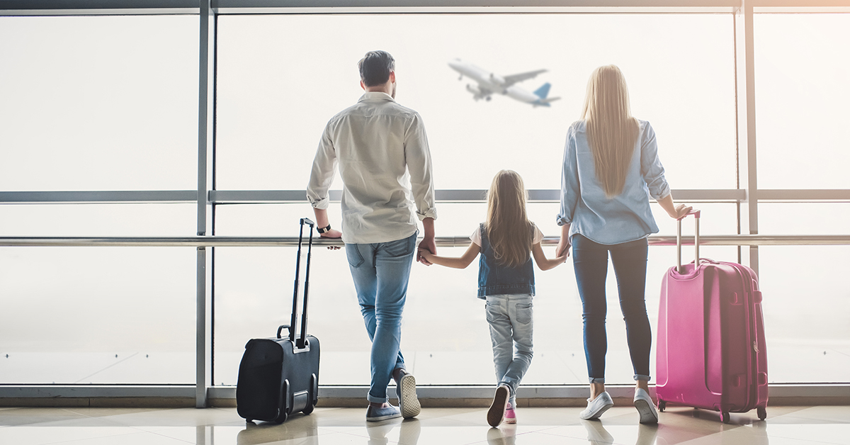 Family in airport. Attractive young woman, handsome man and their cute little daughter are ready for traveling! Happy family concept; blog: 12 Holiday Travel Tips for Families