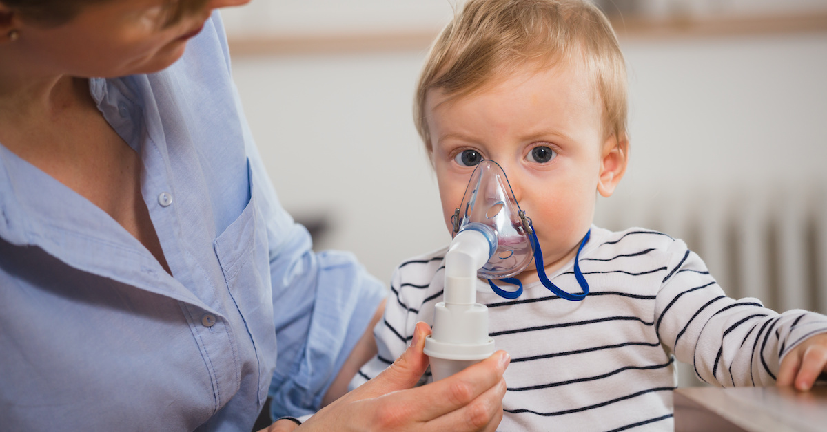 little boy inhaling with nebuliser; blog: Chronic and Acute Illness: What’s the Difference?