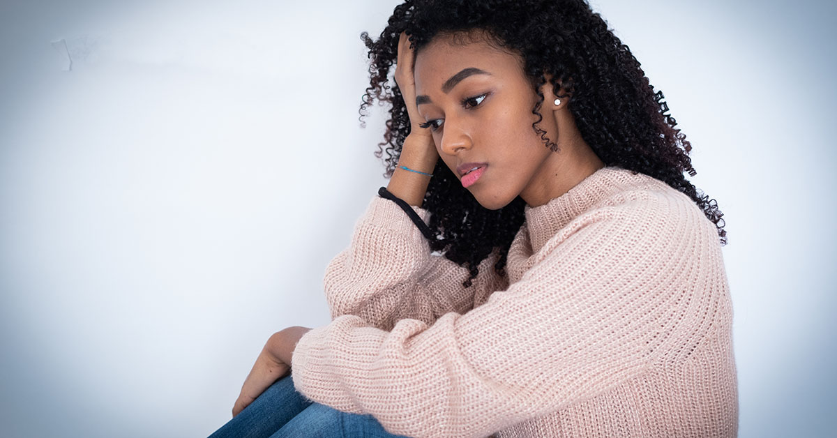 Sad afro-american woman portrait isolated on background; blog: 4 Facts about Women’s Mental Health